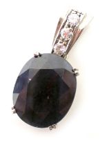 A sapphire and diamond pendant, the oval cut sapphire 15mm x 12mm x 4mm, in four double claw setting