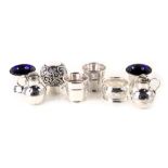 A collection of small silver, to include two beakers, napkin ring, scent bottle lid with cork interi