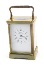 A Rapport French brass carriage time piece, with hinged handle, 17cm high.
