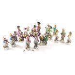 A collection of monkey band figures, to include two conductors, a figure seated on another monkey pl