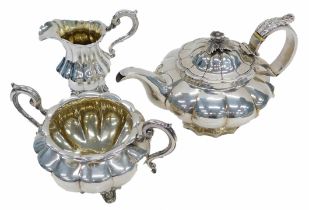 A matched early 19thC silver tea set, a teapot, London 1817, milk jug and two handle sugar bowl, Lon