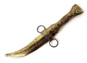 A Middle Eastern dagger, with embossed brass scabbard and handle and belt loop, 27cm long.