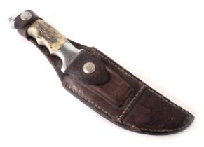 A hunting knife, by RH Ruana of Bonner, Montana, with antler style handle and leather scabbard, 28cm