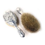 Two Edward VII silver dressing table brushes, each with embossed cherub design, Chester 1901. (2)