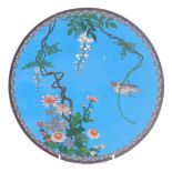 A late 19th/early 20thC Japanese cloisonne charger, decorated with a bird, flowers, etc., on a blue