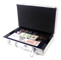 An aluminium coin case and contents, to include collectors fifty pence pieces, WWF, football medalli