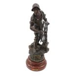 A 19thC French bronzed spelter figure of a sailor with ship's wheel, on a simulated marble base, 65c