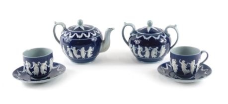 A Copeland ceramic part tea set, decorated in Wedgwood style with raised neoclassical figures in whi