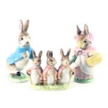 Three Beswick Beatrix potter figures, comprising Peter Rabbit, Flopsy, Mopsy, and Cotton Tail and Mr