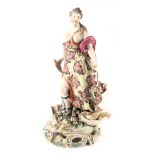 An 18thC Derby porcelain figure, modelled in the form of a lady holding a fish beside an urn, etc. o