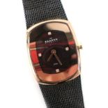 A Skagen Danish ladies wristwatch, the oval shaped dial with red lustre backing, four gem set marker