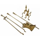 A set of three brass fire irons and a pair of fire dogs.