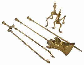 A set of three brass fire irons and a pair of fire dogs.