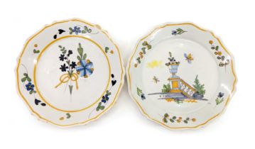 An early 20thC French Faience plate, decorated with a balustrade and urn, and another decorated with