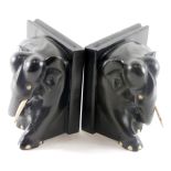 A pair of African ebony bookends, carved with an elephant with bone inlaid feet, 16cm wide.