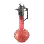 A WMF acid etched cranberry tinted glass and pewter mounted claret jug, the lid, handle etc. decorat