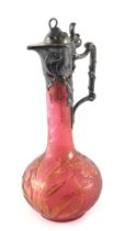 A WMF acid etched cranberry tinted glass and pewter mounted claret jug, the lid, handle etc. decorat