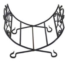 A wrought iron folding log stand, with side handles, 50cm wide.