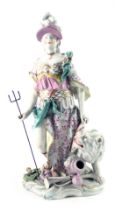 A continental porcelain figure of Britannia in Derby style, standing beside a lion, carrying a