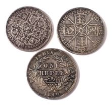 A Victoria 1646 silver one rupee coin, an 1849 florin, and an 1887 florin.