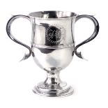 A George III silver and copper loving cup, the two scroll handles and central crest bearing the