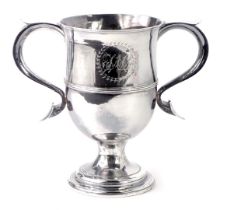 A George III silver and copper loving cup, the two scroll handles and central crest bearing the