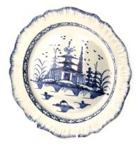 A late 18th/early 19thC pearl ware blue and white cabinet plate, decorated with a central panel of b