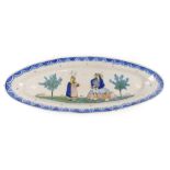 A 19thC large Quimper Faience oval platter, decorated with a lady with a basket and a gentleman play