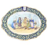 A 19thC Porquier Beau oval Faience platter, La Sortie D'eglise mark to underside in blue with title