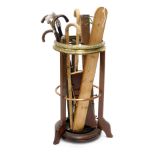 An early 20thC mahogany brass and copper banded umbrella stand, or stick stand, and various walking