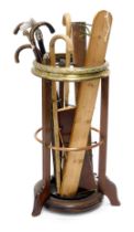 An early 20thC mahogany brass and copper banded umbrella stand, or stick stand, and various walking