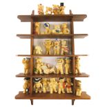 A large collection of ceramic bears, each wearing costume, etc., and a shelf.