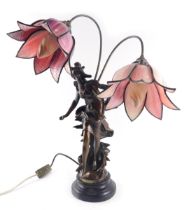 A bronzed resin Art Nouveau style table lamp, with two branches, each with coloured stain glass peta