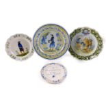 Four French faience cabinet plates and chargers, comprising an early 19thC Quimper plate, decorated