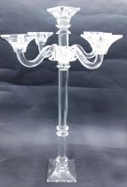 A large cut glass five branch candelabra, with faceted stem and tapering square foot, in the manner