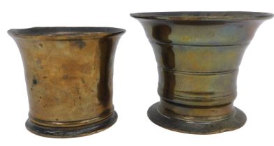 An 18th or 19thC bell metal mortar, with moulded design, 9cm high, and a plain example, 8cm high. (A