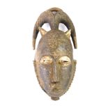 An African tribal Baule meditation peale mask, Cote D'Ivoire circa 1950, 30cm high.