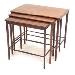 A nest of three Danish Control rosewood tables, each with rectangular top and turned tapering legs,