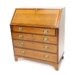 An early 19thC oak and mahogany cross banded bureau, the fall enclosing a fitted interior above four