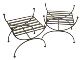 A pair of wrought iron stands, each with a slatted top and X shaped end supports, 50cm wide.