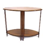A late Arts and Crafts style ovoid two tier mahogany occasional table, the top with a moulded edge o