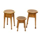 Three oak and beech Arts and Crafts style occasional table, each with a circular top inset with brow