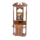 A late Victorian style hardwood hall stand, the top with a swan neck pediment centred by finial abov