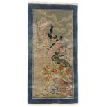 A Chinese rug, decorated with birds on branches, on a cream ground, 63cm x 120cm.