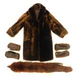 A brown three quarter length fur coat, scarf, and two pairs of gloves.