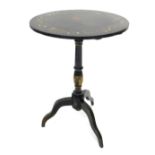 An ebonised tilt top occasional table, the circular top elaborately painted with animals, to include
