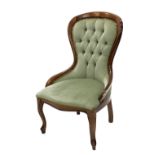 A French style beech nursing chair, with green upholstered button back bordered with brass studs, an