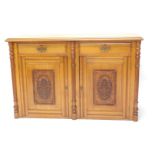 A late Victorian oak sideboard, the top with a moulded edge, above two frieze drawers, and two carve