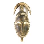 An African tribal Baule crescent mask, Cote D'Ivoire, circa 1965, 42cm high.