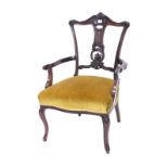 A late 19th/early 20thC walnut salon armchair, with a carved pierced splat, gold upholstered padded